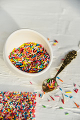 culinary sprinkling, cooking dressing in a Cup with a spoon on light background, close up