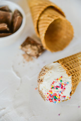 Ice-Cream Plombir In A Waffle Cup With A Topping Of Fresh Blueberries And Syrup, Grated Chocolate, Sprinkles, Overhead View.