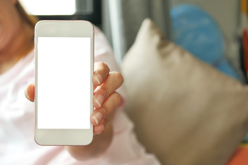 Women hands holding smart phone with blank screen. close up shot.vintage lighting effect.