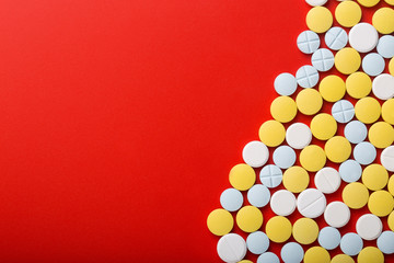 Obraz premium Medical pills . On red background. Top view . Medicine concept