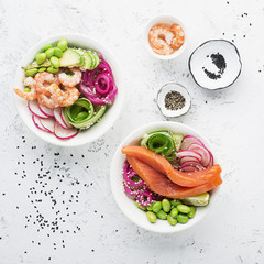 Fresh seafood recipe. Shrimp salmon poke bowl with fresh prawn, brown rice, cucumber, pickled sweet...
