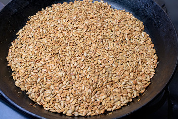 Roasted sunflower seeds in a black skillet