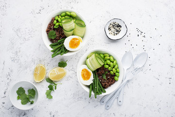 Rice vegetables bowl. Red fragrant jasmine rice with soybeans edamame, thin string beans, fresh cucumbers, zucchini and eggs for a healthy snack, lunch. Top View