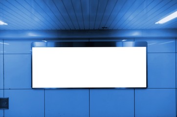 big blank advertising billboard or light box showcase on wall at subway train station, copy space for your text message or media content, advertisement, commercial and marketing concept, blue tone
