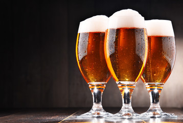 Composition with three glasses of lager beer