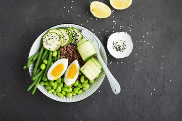 Rice vegetables bowl. Red fragrant jasmine rice with soybeans edamame, thin string beans, fresh cucumbers, zucchini and eggs for a healthy snack, lunch. Top View