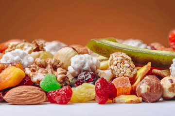 Tasty sweet mix dried fruits colorful background. A set of textures of nuts, legumes and dried fruits. 