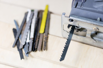 Fototapeta premium Carpentry tools on a wooden workshop table. Saw and other carpentry accessories while working in a carpentry workshop.