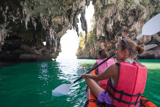 Women are kayaking in the sea caves at the Krabi shore, Thailand