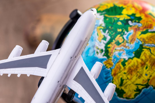 a toy airplane on globe cloae up