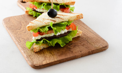Sandwich with ham, cheese, tomatoes and fresh salad.