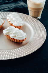 Delicious fresh cakes white protein cream and coffee.