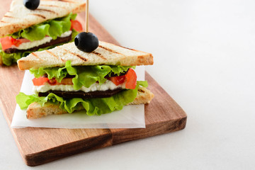 Sandwich with ham, cheese, tomatoes and fresh salad.