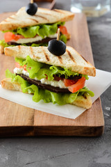 Sandwich with ham, cheese, tomatoes and fresh salad.