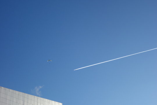 Blue clear sky with glider and plane trail
