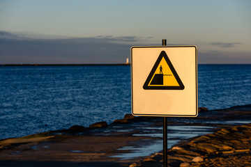 attention signs near sea with stormy weather