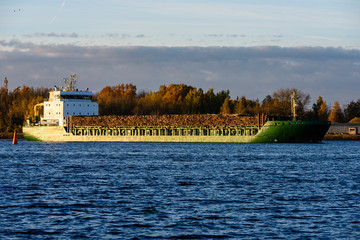 Naklejka premium cargo ship is leaving port sailing away