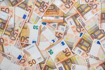 50 new and old euro bills as background