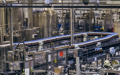 Conveyor belt of brewery production line . Beer polyethylene PET bottles are moving on conveyor