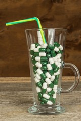 Vitamin cocktail. Pills in a glass. Treatment of diseases. Pharmaceutical industry. Healthy lifestyle.