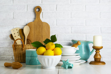 Lemons in a bowl on the table in the kitchen