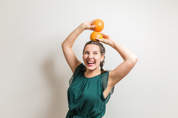 Lovely smiling girl holds fruits