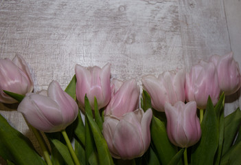 bouquet of tulips on rustic wooden board.