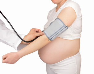 Shot of a doctor checking a mother's  blood pressure against a white background