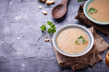 Healthy vegetarian peas soup on concrete background