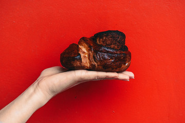 hand holding a cinnamon bun