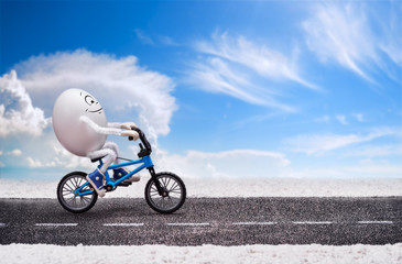 Funny happy smiling egg is riding by the road