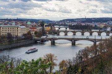 Fototapeta na wymiar Panoramic view of Vltava river with boat and bridges. Concept of Europe travel, sightseeing and tourism.