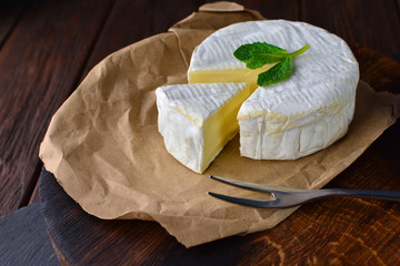 Very tasty cheese on an aged oak kitchen board.