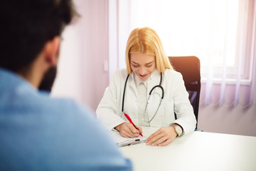 Female doctor filling patient registration form. Healthcare and medical concept