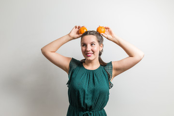 Very beautiful girl plays with fruits