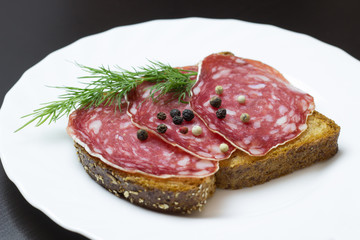 Fresh sandwich with ham and dill, on the table