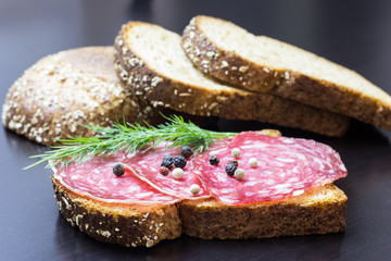 Fresh sandwich with ham and dill, on the table