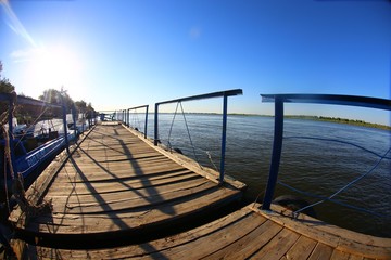 wooden pier with boats on the Volga river