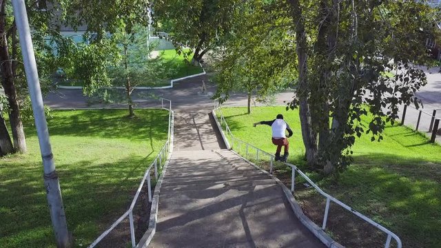 Aggressive inline roller blader grind on rail in skatepark outside. Clip. Summer extreme sport exercising outdoor in skate park. Skater guy grinding on railing in park. Cool activity hobby for young