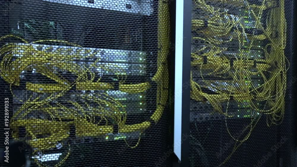 Poster rack mounted servers in a server room, server rack audio cable. severs computer in a rack at the lar