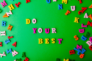 Do your best. Scattered colorful wooden letters