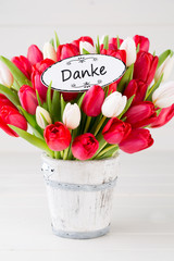 Springt time. Red tulip bouquet on the white wooden background.
