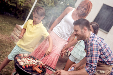 Family having a barbecue party in a sunny day.