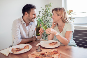 Obraz na płótnie Canvas Young couple enjoying eating pizza.
