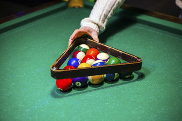 person plays billiards
