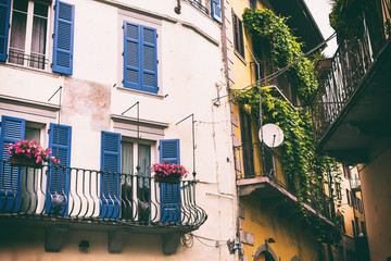 Close-up of balconies of houses on the street of an old Italian city.Toned photo.