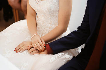 Wedding couple holding hands with love and tenderness. Wedding rings. Man giving an engagement ring...