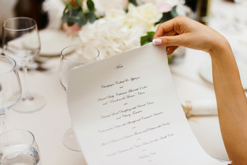 Beautiful woman looking at menu in italian restaurant clode sup macro photo