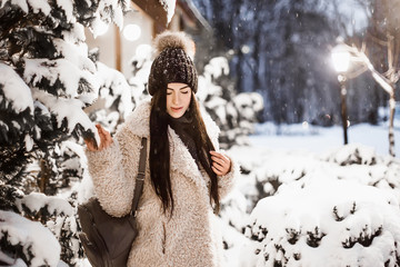 Woman walking in winter evening.