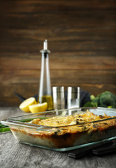 Glass baking dish with tasty broccoli casserole on table. Fresh from oven